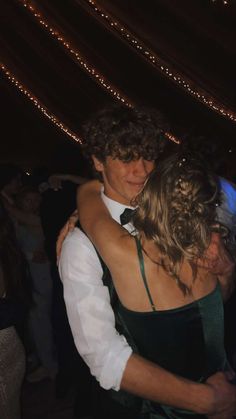 two people hugging each other at a party