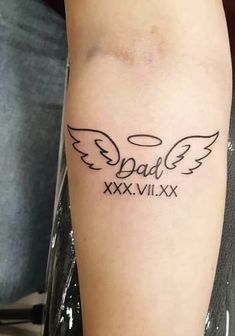 a person with a tattoo on their arm that says dad and xxxvix