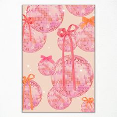 a pink and orange christmas ornament with bows on it's side is featured against a white wall