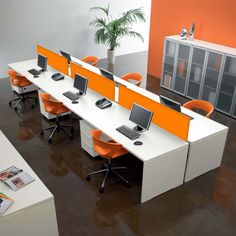 an office cubicle with orange and white desks