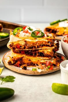 several quesadillas stacked on top of each other with salsa in the background