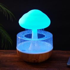 a blue mushroom lamp sitting on top of a wooden table