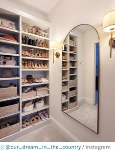 a large mirror sitting on top of a white wall next to a walk in closet