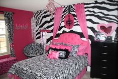 a zebra print bedroom with pink and black decor