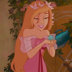 the princess from disney's sleeping beauty holding a blue bird in her right hand