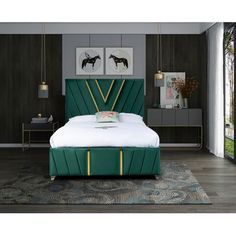 a bed with green headboard and gold trimmings in front of a large window