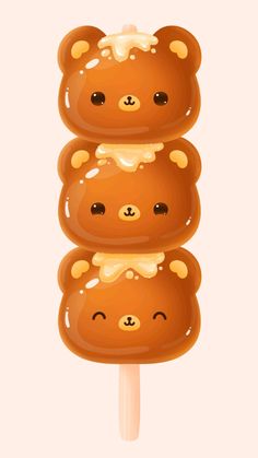 three brown bears sitting on top of a popsicle