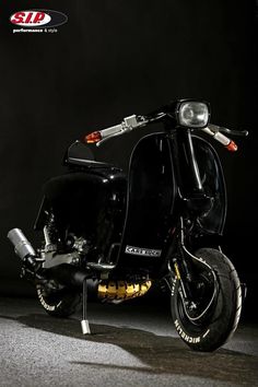 a black scooter is parked in the dark