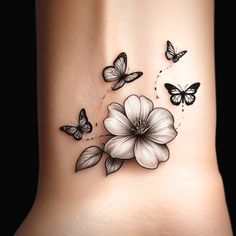 a woman's foot with butterflies and flowers on the side of her body,