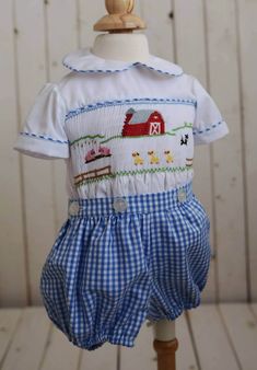 "Little boys button on suit with farm smocking. MADE-TO-ORDER.  Size 3m thru 3T available.   Please specify size when ordering.  Also, the shirt is white, you choose the bottom color. This sweet set is perfect for little boys!  The top is made from white imperial broadcloth and smocked with a farm scene with  big red barn in the center.  Gingham piping edges the collar and sleeves.  The blue gingham bloomers button on to the top at the waist.  There is elastic in the legs.  Snaps in the stride a Bloomer, Big Red Barn, Smocking Plates, Child Fashion, Smocking Patterns, Vintage Baby Clothes, Check Suit, Baby Boy Clothing Sets, Farm Scene