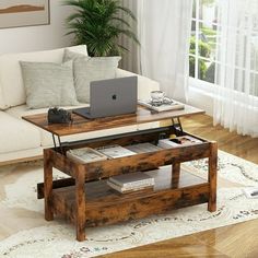 a coffee table with a laptop on it