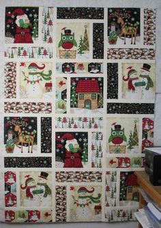 a christmas quilt hanging on the wall