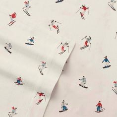 a white sheet with skiers on it and red, blue, and white sheets