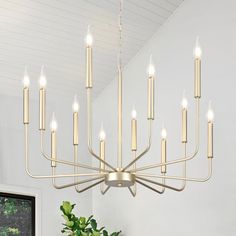 a large chandelier with many lit candles hanging from it's center point