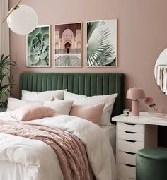 a bedroom with pink walls, green headboard and pictures on the wall above the bed