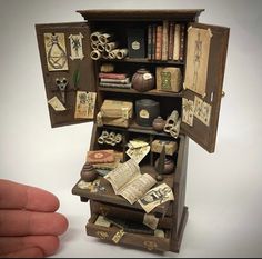 an open book case with many items inside