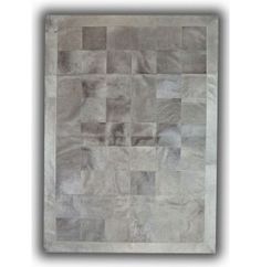 a gray rug with squares and rectangles on it