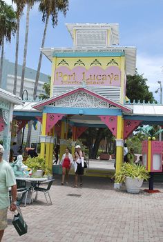 people are walking around in front of a restaurant