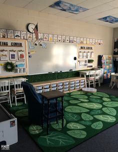 an empty classroom with chairs, tables and chalkboards hanging on the whiteboard wall