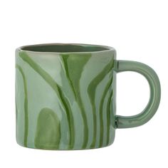 a green coffee mug with wavy designs on it's sides and inside the cup