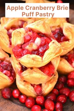 cranberry brie puff pastry is piled on top of other pastries and berries