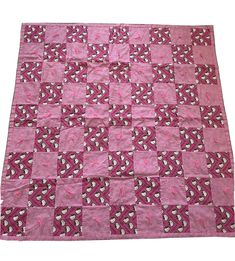 a pink and white quilt with hearts on it