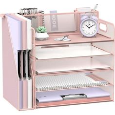 a pink desk with drawers and a clock on the top one shelf is open to show files