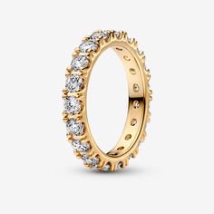 Make a classic statement with the Sparkling Row Eternity Ring. Hand-finished in 14k gold-plated sterling silver, this eternity ring features a band inlaid with sparkling clear cubic zirconia. The design looks equally beautiful worn solo or stacked with other rings. Style it with bands in similar tones to create a monochromatic look, or go for contrasting metals for a combination that pops. A classic silhouette with a modern interpretation, this ring is designed to be a wardrobe essential for yea Pandora Gold Rings, Pandora Rings Gold, Charms Disney, Pandora Essence, Pandora Gold, Bracelet Tennis, Golden Ring, Pandora Rings, Jewellery Uk