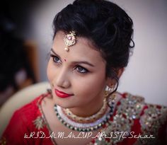 a woman in a red dress with jewelry on her head