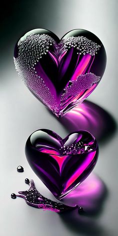 two purple hearts with water droplets on them