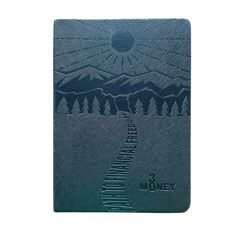 a blue notebook with mountains and trees on the cover, in front of a white background