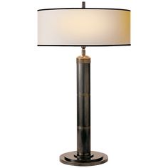 a table lamp with a white shade on top and a black base in the middle