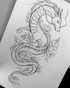 a drawing of a dragon with flowers on it