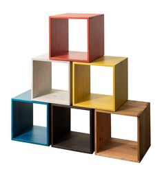 four different colored cubes stacked on top of each other in the shape of boxes