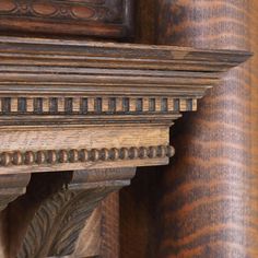 an ornate wooden shelf with decorative carvings on it