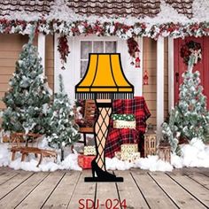 a table lamp sitting on top of a wooden floor in front of a house covered in snow