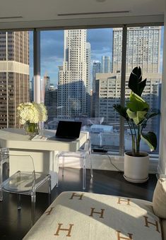 a living room filled with furniture and tall buildings