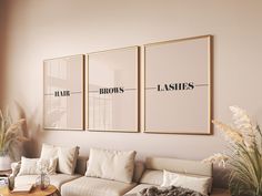 a living room filled with furniture and two framed pictures on the wall next to a coffee table