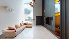 a living room filled with furniture and a flat screen tv sitting on top of a wall