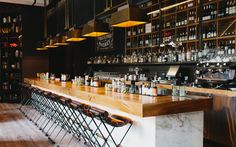 an empty bar with lots of bottles on the shelves