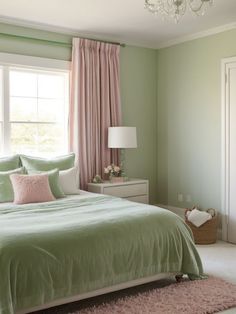 a bedroom with green walls and pink curtains