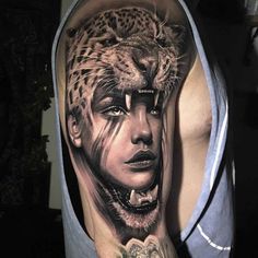 a man's arm with a portrait of a woman and a leopard on it