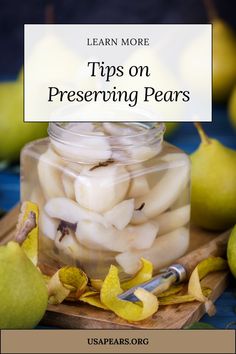 a jar filled with pears sitting on top of a wooden cutting board