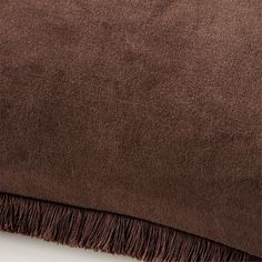 a brown blanket with fringes on it