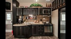 a kitchen with black cabinets and stainless steel appliances