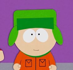 a paper cut out of south park character with an orange shirt and green beanie