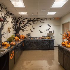 an office decorated for halloween with pumpkins and bats on the wall, along with other decorations