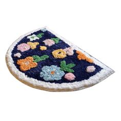 a blue and white rug with flowers on the bottom is shown in front of a white background