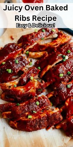 ribs covered in bbq sauce and garnished with scallions on a cutting board