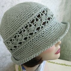 a crocheted hat is shown on a mannequin head